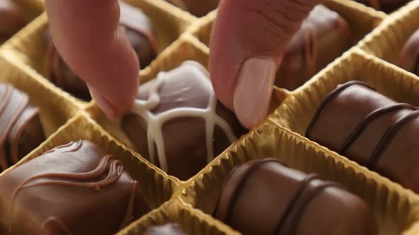 Female hand over  luxurious set of many different sweets 4K 2160p 30fps UltraHD footage - Woman pick alt