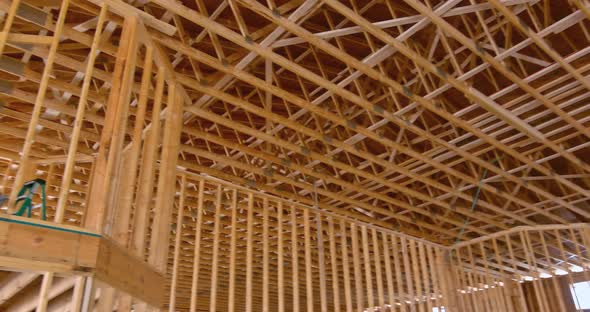 Interior View of a New Home Construction Showing the Entire Wood Roof Trusses alt