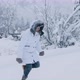 Happy Smiling Young Woman Jumping Into High White Snowdrift on Winter Cold Day - VideoHive Item for Sale