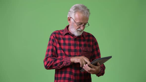 Handsome Senior Bearded Man Against Green Background alt
