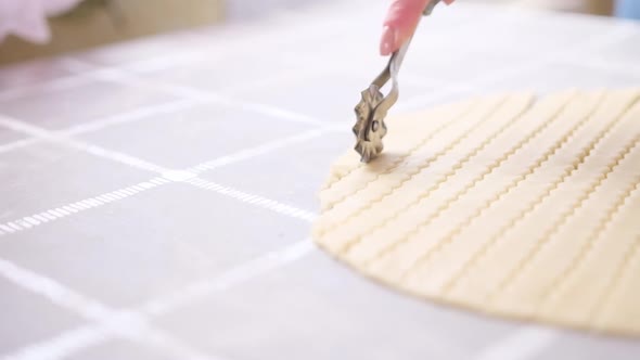 Apple Pie Cake Preparation Series  Woman Slicing Rolled Dough with Rolling Knife alt