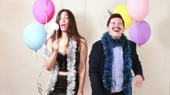Happy crazy couple enjoying in photo booth alt