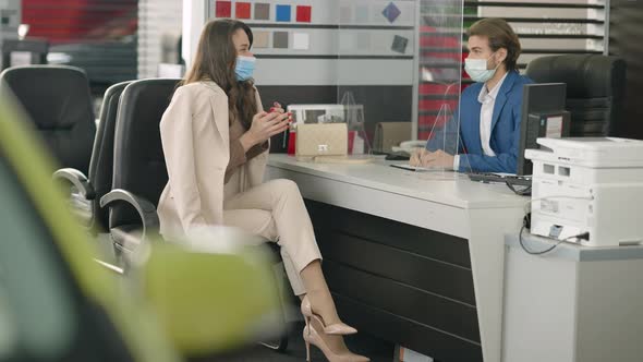 Gorgeous Slim Young Woman in Covid19 Face Mask Receiving Car Keys From Dealer in Showroom alt