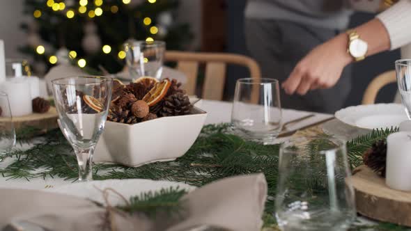 Couple preparing table for Christmas Eve. Shot with RED helium camera in 8K alt