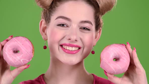 Teenager Sniffs Two Donuts. Green Screen alt