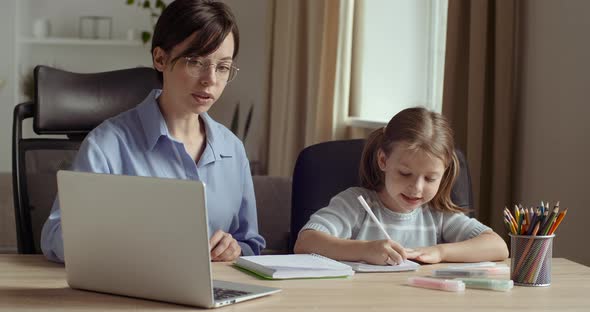 Young Woman Teach Girl with Laptop Online in Net, Shows Child on Screen of Computer, Checks Task alt