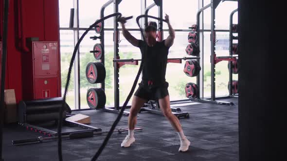 Muscular Man is Engaged in the Gym