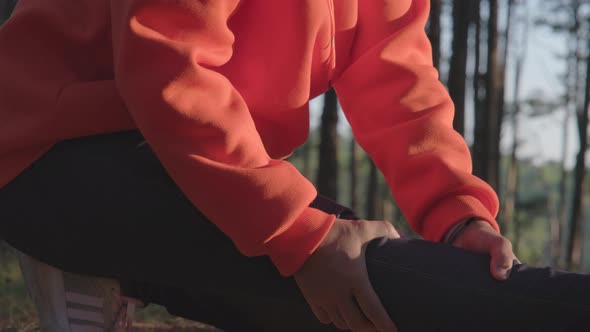 A female runner is massaging her cramping legs while running. Athletes injured during exercise. alt