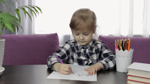 Cute Child Girl Studying Drawing Picture with Pencil at Home. Distance Education alt