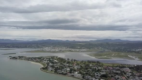 Knysna River Lagoon, quiet Leisure Isle and surrounding hills, aerial alt