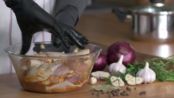 Chicken marinade and spice mix process. Chef prepares marinade and stirs raw chicken legs in glass alt