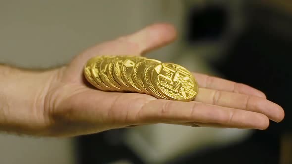Slow Motion Man Tosses Coins in Hand Created As Bitcoin Currency alt
