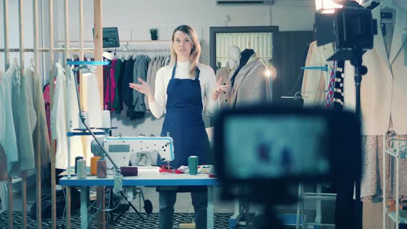 Female Dressmaker is Filming a Vlog in Her Workshop alt