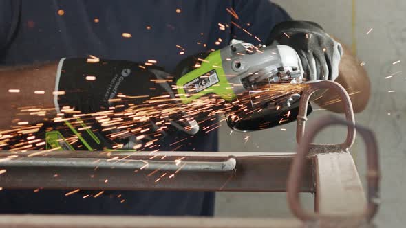 Slow motion of a metal grinder during work with sparks flying