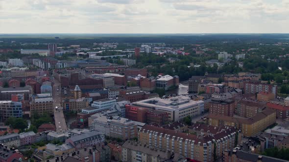 Downtown and street traffic in Norrkoping city in aerial drone view alt