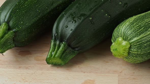 Fresh zucchini on cutting board, on wooden background