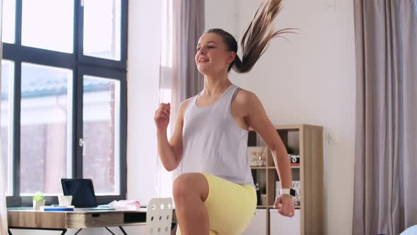 Smiling Teenage Girl Running on Spot at Home