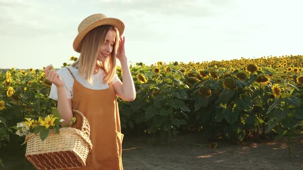 A Woman with a Basket of Flowers is Looking at the Camera and Smiling alt