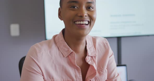 Portrait of smiling african american businesswoman laughing in meeting room alt
