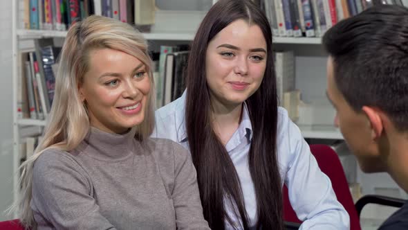 Beautiful College Girls Laughing, Talking To Their Classmate at Campus Library alt