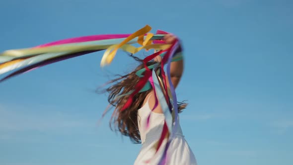 Girl Whirls, Plays with Colorful Ribbons, Slow-motion alt