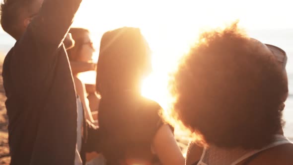 Friends Smiling Laughing Speaking Walking at Seaside at Sunrise alt