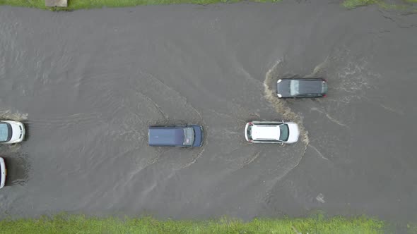 Aerial View of City Traffic with Cars Driving on Flooded Street After Heavy Rain alt