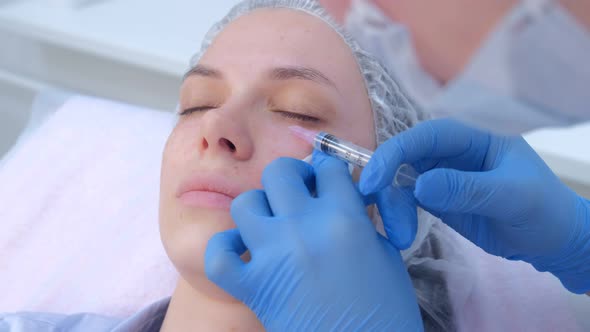 Beautician Is Making Multiple Injections Biorevitalization in Woman Face Skin