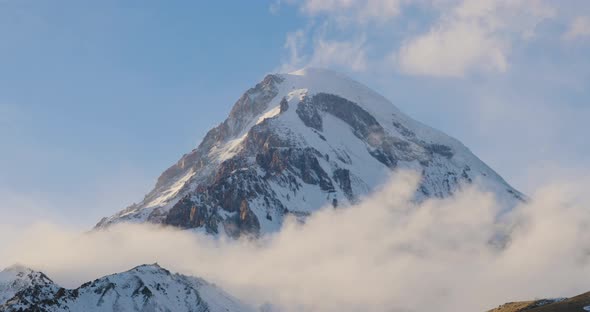 Stepantsminda, Gergeti, Georgia. Peak Of Mount Kazbek Covered Snow In Winter Landscape. alt