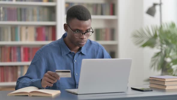 Excited Young African Man Shopping Online on Laptop alt
