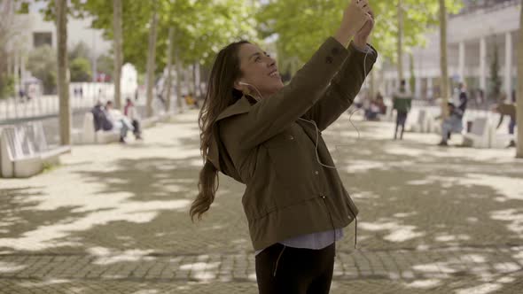 Smiling Young Woman Having Video Call Through Smartphone alt