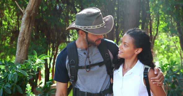 Romantic couple interacting with each other in park alt