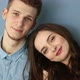 Young Couple in Love Sitting at Home By the Blue Wall - VideoHive Item for Sale