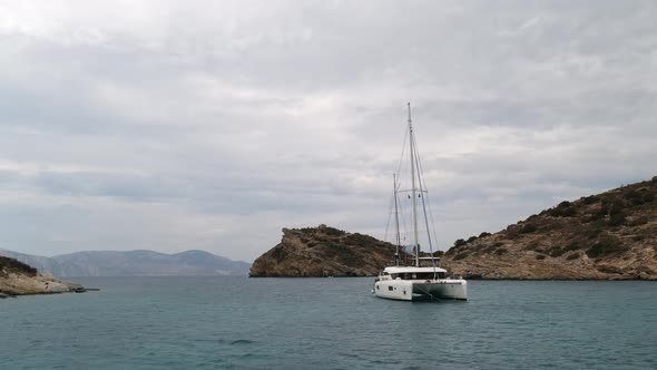 Catamaran Sail Yacht Anchored on Deep Blue Sea Water
