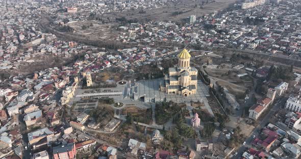 Aerial view of Holy Trinity Cathedral Sameba in Tbilisi Georgia. Sunrise drone footage. alt