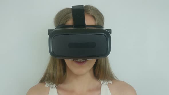 sexy woman in a virtual reality helmet uses the application alt