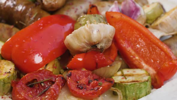 Portion of Grilled Sausages on Pita Bread with Baked Zucchini Tomatoes Garlic Paprika