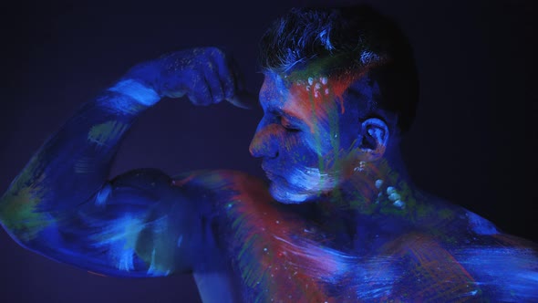 Portrait of a Muscular Guy with UV Paint on His Skin alt