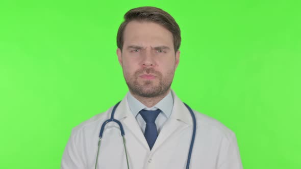 Young Doctor in Denial on Green Background alt