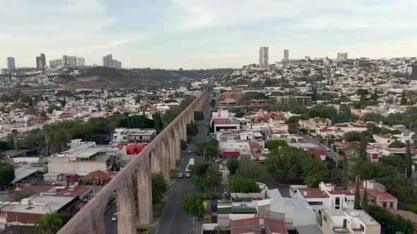 Acueducto de Queretaro In Middle Houses And Buildings In City Of Queretaro In Mexico. - aerial pullb alt
