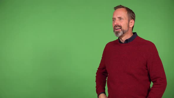 A Middleaged Caucasian Man Shades His Eyes with His Hand and Looks Around  Green Screen