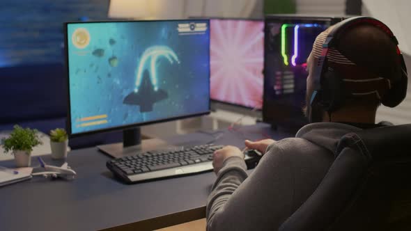 Back Shot of Pro Gamer Playing Online First Person Game alt