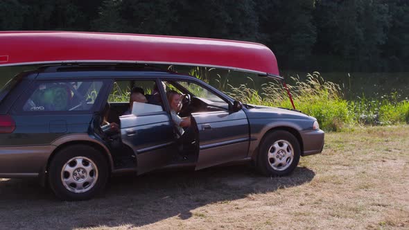 Family parks car at campsite alt