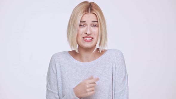 Young Beautiful Shy and Embarrassed Blonde Girl Over White Background alt