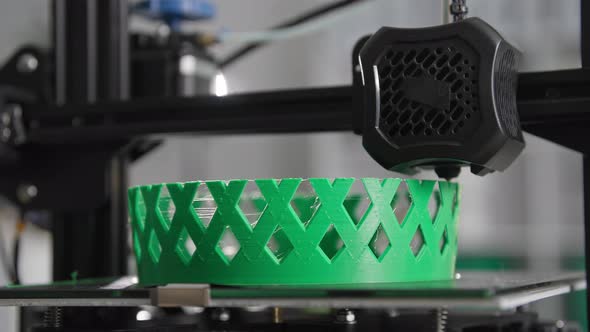 Modern Technologies at Home Automatic 3D Printing Prints Layer By Layer of Hot Green Plastic alt