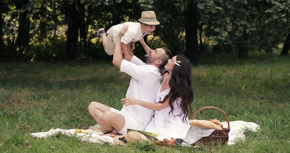 Father and Mother Playing with Son.