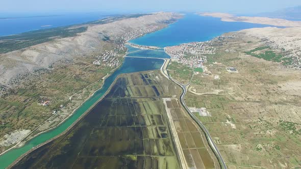 Aerial view of salt pans surrounded by sea and mountains, Pag island, Croatia alt