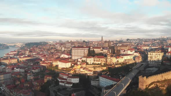Aerial view of the city of Porto (Portugal) and Dom Luis I bridge during sunrise/sunset alt