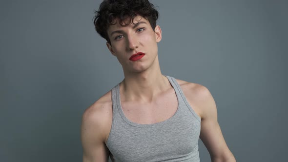 Young Attractive Trans Man with Makeup Saying NO While Crossing His Hands Standing Isolated Over alt