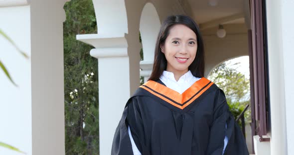 Asian woman get graduation in university campus alt